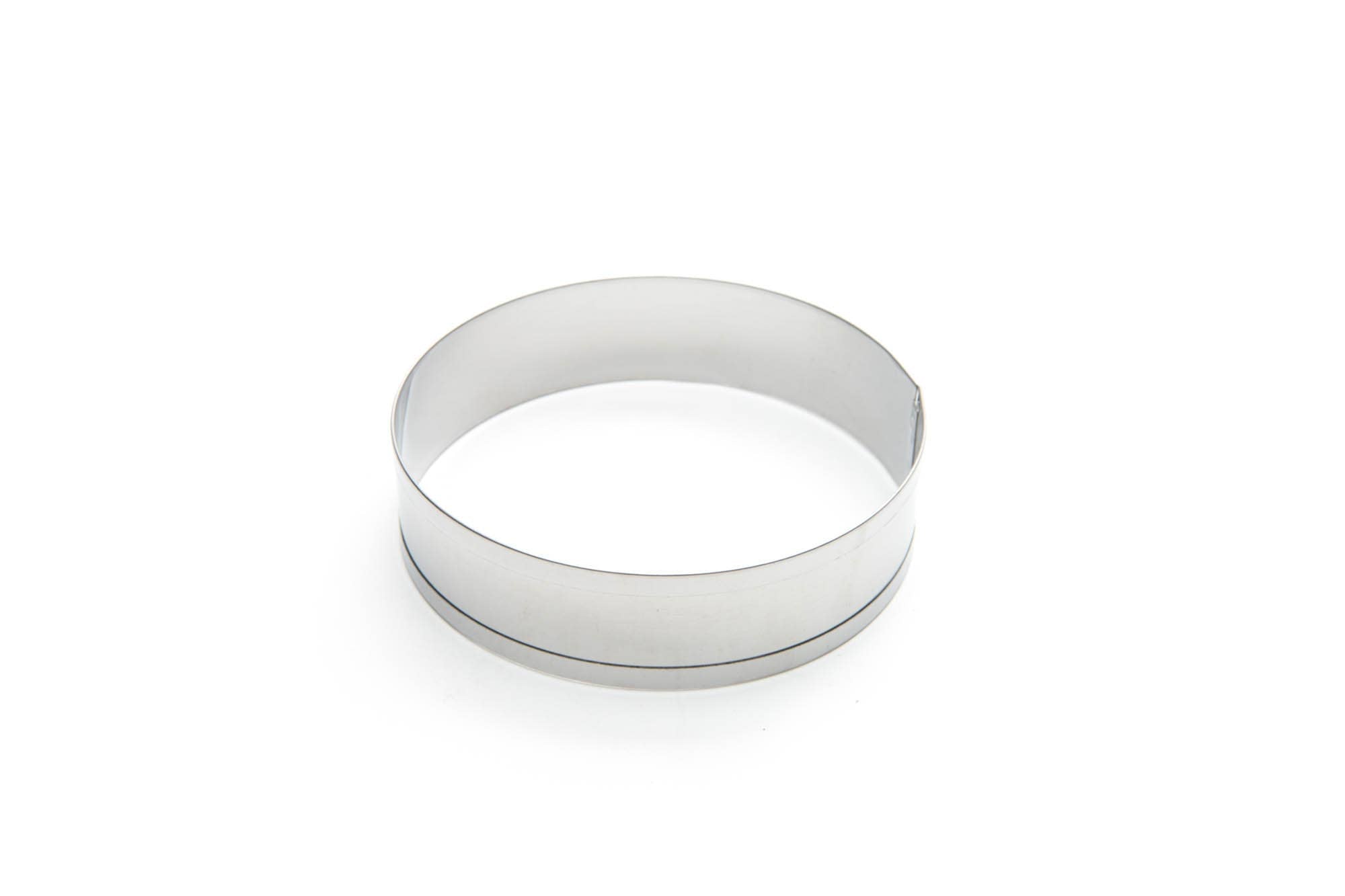 Set of four stainless steel English muffin rings on a white background