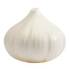 White garlic-shaped ventilated Garlic Saver opened beside a whole head of garlic
